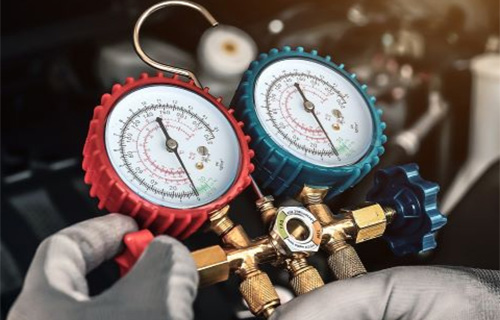 Mechanical gauges are hooked up to a car at a shop for auto repair in Gaithersburg