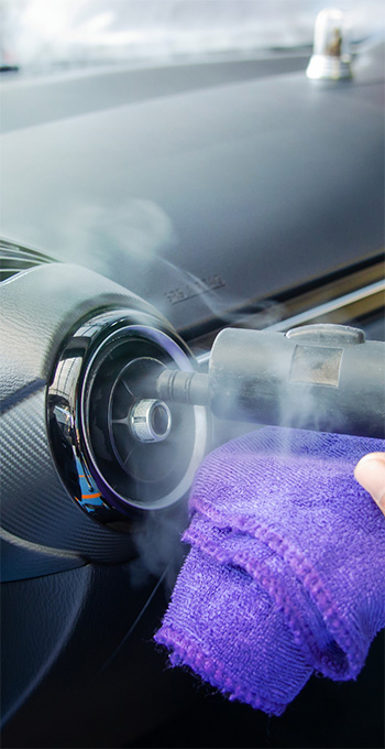 Air vents being cleaned inside a car during air conditioning repair in Gaithersburg