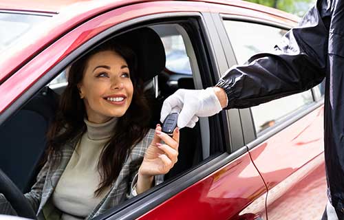 Women in a red vehicle drops off her car for auto care in Gaithersburg, MD