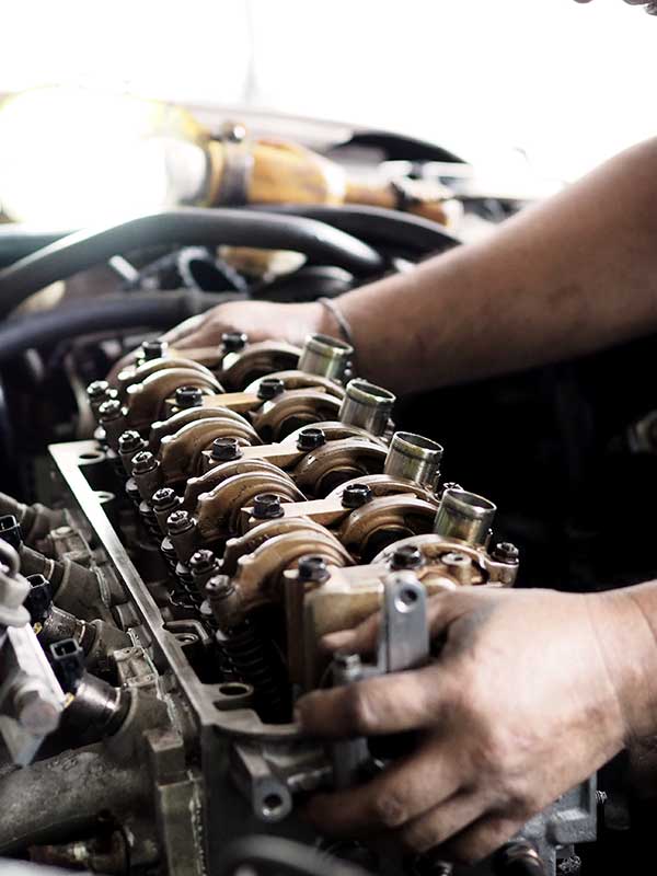 Car engine repair services where a mechanic is pulling out the engine