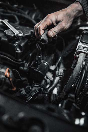 Gloved hands perform transmission services