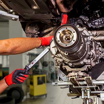 Mechanic working on transmission services at Winkler Automotive