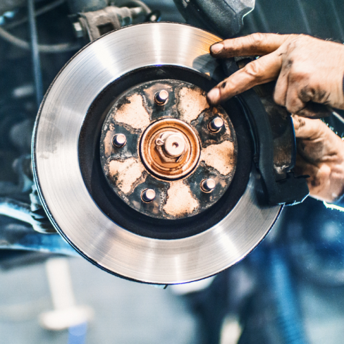 Hands smoothing car brakes during brake service in Gaithersburg