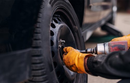 Mechanic installs a new tire during auto care service